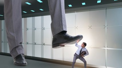 Giant foot of supervisor stepping on a male employee