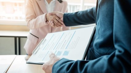 of successful business team shaking hands with each other in the office, job interview concept